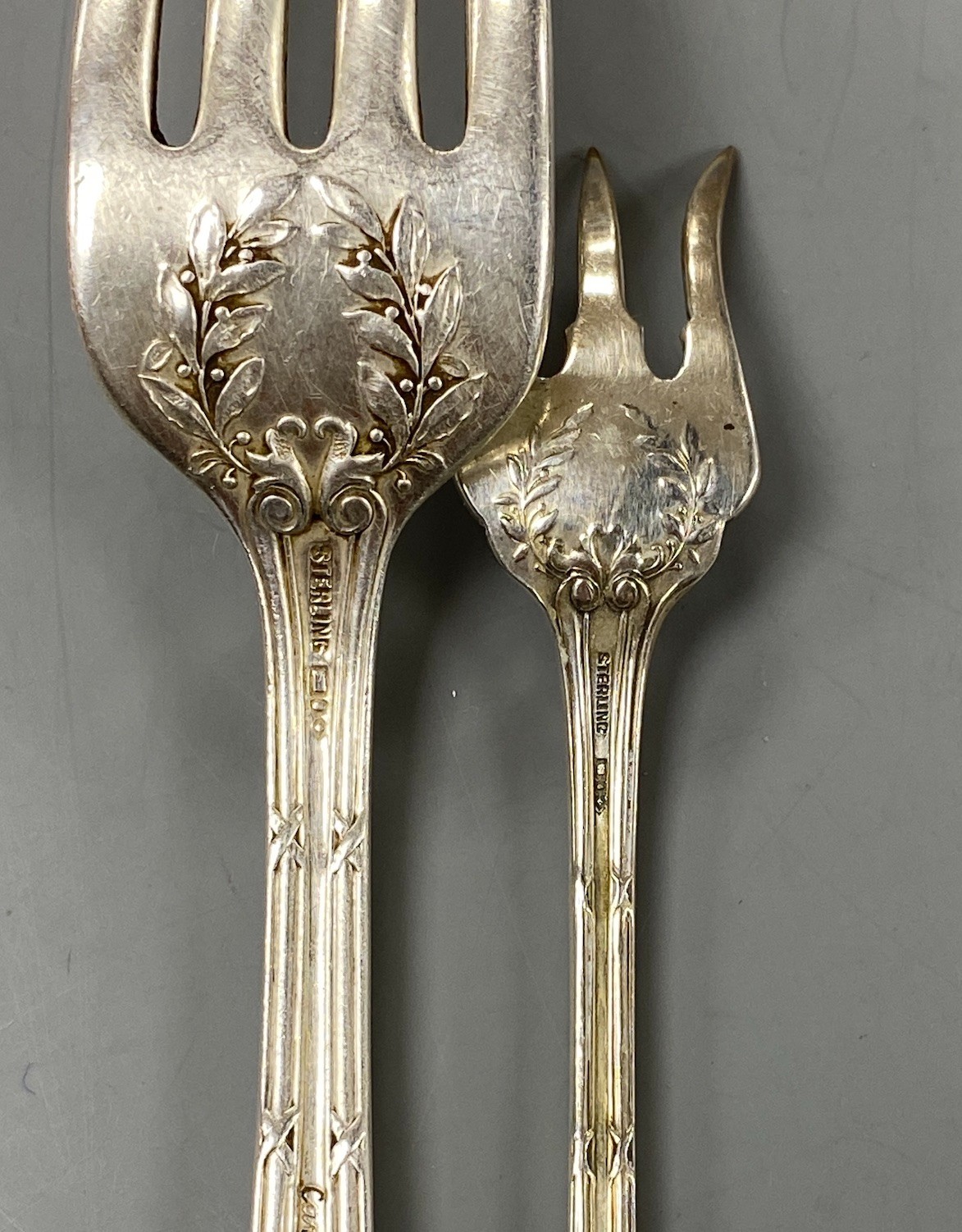 A set of ten Cartier sterling tea forks, 13.4cm and a similar table fork, 9oz.